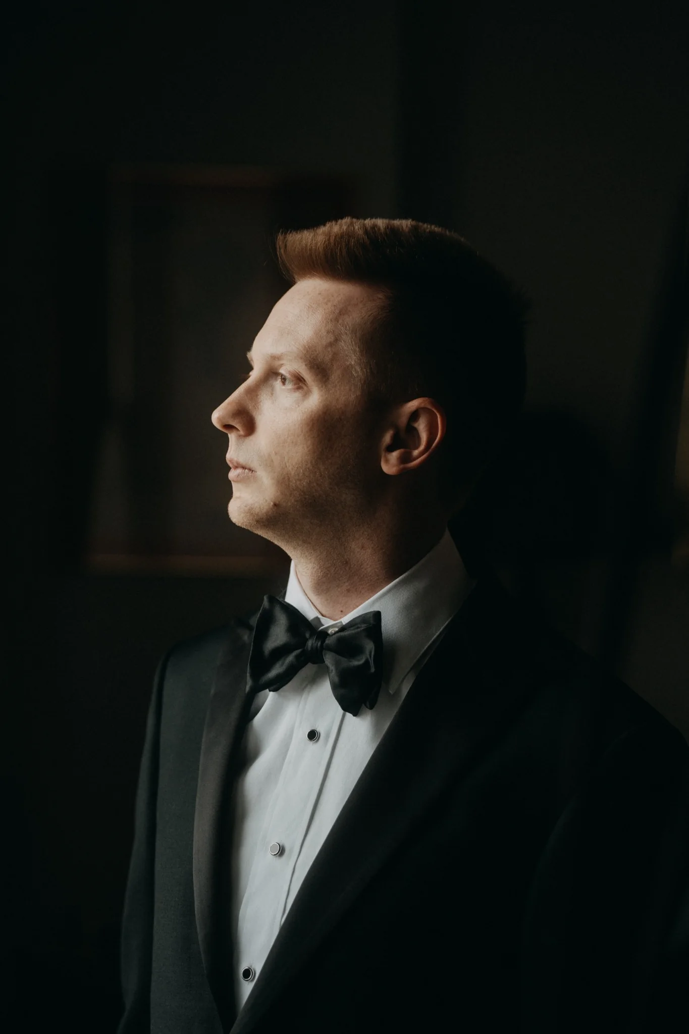Portrait of Birmingham wedding photographer Eric Lucky in a black tuxedo