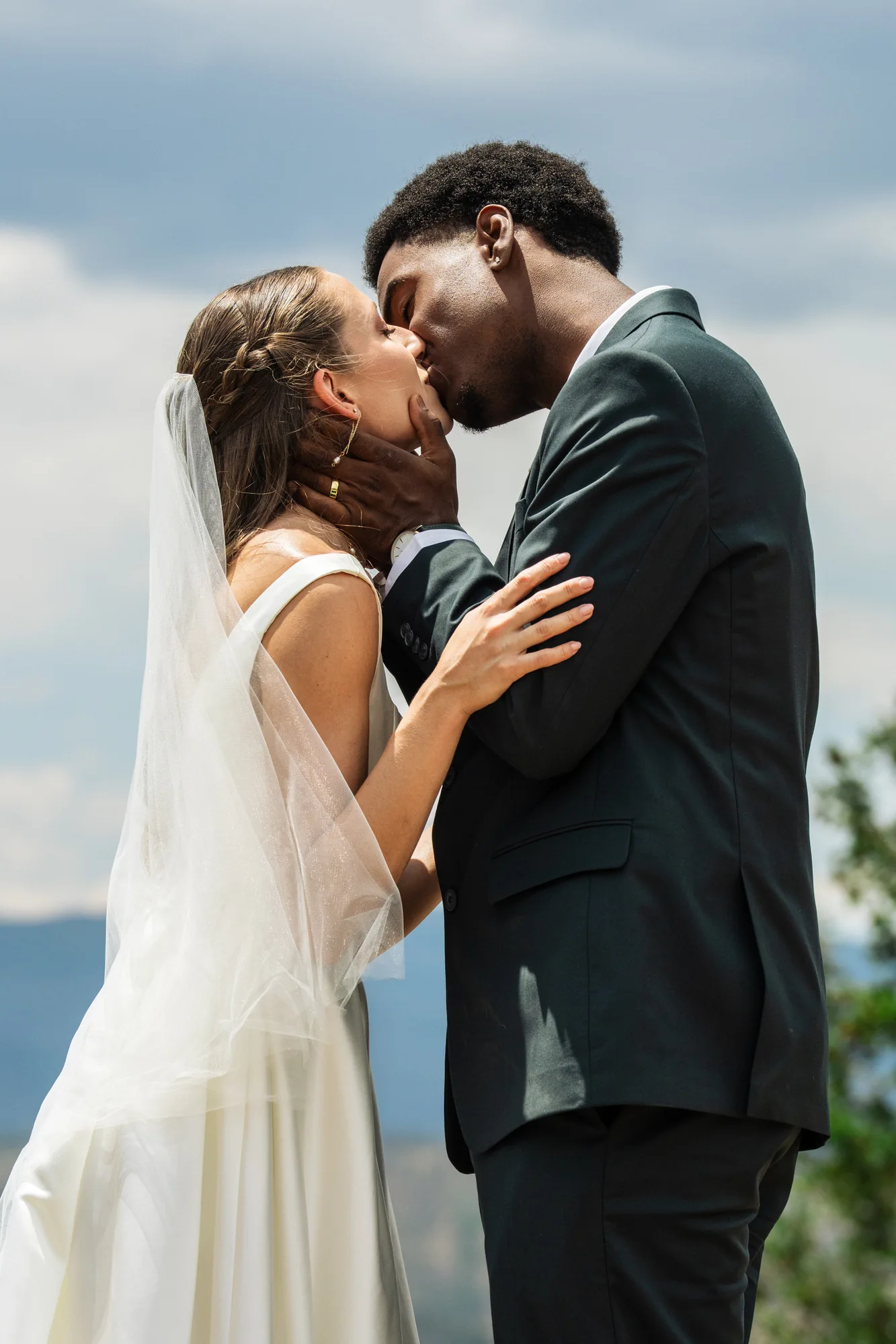 Newly married couple kissing after their vows in the Colorado mountains