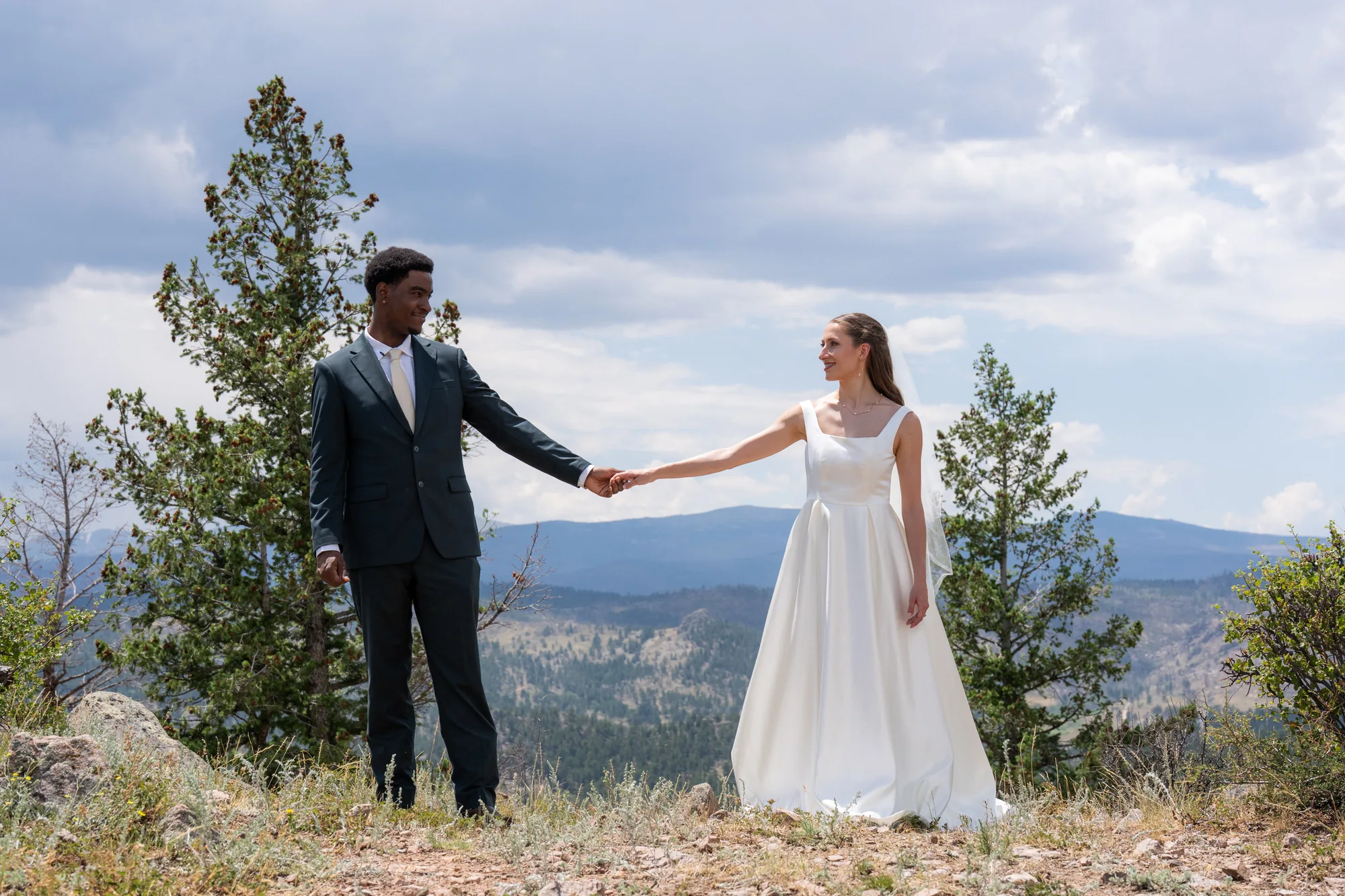 Bride and groom standing together at a mountain overlook after their Colorado elopement
